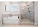 Elegant bathroom featuring a separate tub and glass-enclosed shower at 169 Aspen Hall Dr, Canton, GA 30115