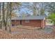 Back view of brick house with trees in the background at 8309 Dunellen Ln, Jonesboro, GA 30238