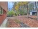 Leaf-covered backyard with detached garage at 8309 Dunellen Ln, Jonesboro, GA 30238