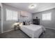 Comfortable bedroom with plush gray carpeting, neutral walls, and filled with natural light at 8309 Dunellen Ln, Jonesboro, GA 30238