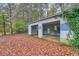 Open detached garage covered in vines and leaves at 8309 Dunellen Ln, Jonesboro, GA 30238