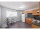 Kitchen with stainless steel appliances, sleek countertops, light wood cabinets, and gray vinyl flooring at 8309 Dunellen Ln, Jonesboro, GA 30238