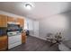 Bright kitchen with stainless steel appliances, sleek countertops, light wood cabinets, gray vinyl flooring and a glass table at 8309 Dunellen Ln, Jonesboro, GA 30238