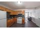 Cozy kitchen with stainless steel appliances, sleek countertops, light wood cabinets, and gray vinyl flooring at 8309 Dunellen Ln, Jonesboro, GA 30238