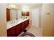 This primary bathroom features a large vanity with dual sinks and a tile floor at 980 Yancey Ct, Loganville, GA 30052