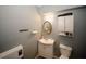 Bathroom features a clean vanity, toilet, mirror, and storage cabinet at 980 Yancey Ct, Loganville, GA 30052