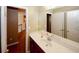 Bright bathroom with a large mirror and vanity, offers access to additional storage and bathroom, enhancing convenience at 980 Yancey Ct, Loganville, GA 30052