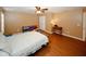 Spacious bedroom with wood floors, a ceiling fan, and colorful storage, offering comfort and style at 980 Yancey Ct, Loganville, GA 30052