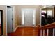 Bright foyer featuring hardwood floors and a glimpse into an adjacent room with multiple windows at 980 Yancey Ct, Loganville, GA 30052