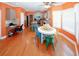 A warm kitchen and dining area with bright orange walls and new hardwood floors at 980 Yancey Ct, Loganville, GA 30052