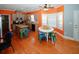 A spacious kitchen and dining area with bright orange walls and new hardwood floors at 980 Yancey Ct, Loganville, GA 30052