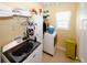 Laundry room with modern washer and dryer, shelving, and a bright window at 980 Yancey Ct, Loganville, GA 30052