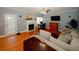 Inviting living room featuring hardwood floors, a fireplace, a comfortable sofa, and a ceiling fan at 980 Yancey Ct, Loganville, GA 30052