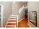 Inviting entryway showcasing a staircase with hardwood treads and floors, and neutral wall paint at 980 Yancey Ct, Loganville, GA 30052