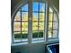 Large arched window offering abundant natural light and views of the lush greenery at 104 Grand Cres, Alpharetta, GA 30009