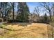 Expansive backyard with mature trees and a basketball court, perfect for outdoor activities at 18 Blackland Nw Rd, Atlanta, GA 30342