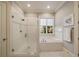 A bright bathroom with a glass-enclosed shower and a separate soaking tub with window views at 18 Blackland Nw Rd, Atlanta, GA 30342