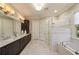 A luxurious bathroom with a dual vanity, soaking tub, and a glass-enclosed shower at 18 Blackland Nw Rd, Atlanta, GA 30342