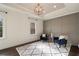 Sitting area in bedroom features a decorative ceiling and two chairs with an area rug at 18 Blackland Nw Rd, Atlanta, GA 30342