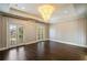 Spacious bedroom has a decorative chandelier and access to outdoor patio at 18 Blackland Nw Rd, Atlanta, GA 30342