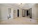 Spacious primary bedroom featuring light hardwood floors, tray ceiling, and natural light at 18 Blackland Nw Rd, Atlanta, GA 30342