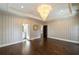 Bedroom has a decorative chandelier and a door leading into another room at 18 Blackland Nw Rd, Atlanta, GA 30342