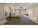 A well-lit bedroom features a bed with bedside tables, arched windows, and a patterned rug at 18 Blackland Nw Rd, Atlanta, GA 30342