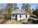 Charming white-brick home with manicured backyard, screened porch and lush landscaping at 18 Blackland Nw Rd, Atlanta, GA 30342