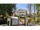 Beautiful gated entrance leading to a stately white brick home surrounded by trees at 18 Blackland Nw Rd, Atlanta, GA 30342