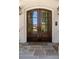 Elegant, arched, wood double doors with glass panels and stone tiling at 18 Blackland Nw Rd, Atlanta, GA 30342