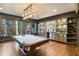 Well-lit game room featuring a pool table, custom cabinets, and a wet bar at 18 Blackland Nw Rd, Atlanta, GA 30342