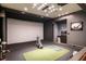 Home golf simulator with a large projector screen and golf equipment at 18 Blackland Nw Rd, Atlanta, GA 30342