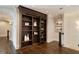 Hallway with dark wood floors and built in bookcase with sliding ladder at 18 Blackland Nw Rd, Atlanta, GA 30342