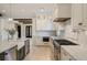 Kitchen featuring marble counters, a farmhouse sink, and stainless steel appliances at 18 Blackland Nw Rd, Atlanta, GA 30342