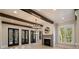 Bright living room with a fireplace, French doors, and wooden beam ceilings at 18 Blackland Nw Rd, Atlanta, GA 30342