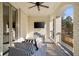 Covered patio with ceiling fan, TV, comfortable seating, and iron railing at 18 Blackland Nw Rd, Atlanta, GA 30342