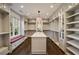 Spacious walk-in closet featuring custom shelving, center island, and hardwood floors at 18 Blackland Nw Rd, Atlanta, GA 30342