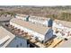 Aerial view of a community with neat rows of townhomes, showing rooftops, decks, and parking areas at 2145 Old Georgian Nw Ter, Atlanta, GA 30318