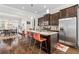 Open kitchen layout with a central island, stainless steel appliances, and dark cabinets at 2145 Old Georgian Nw Ter, Atlanta, GA 30318