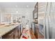 Bright kitchen featuring an island with seating, stainless steel appliances, and dark wood cabinets at 2145 Old Georgian Nw Ter, Atlanta, GA 30318