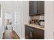 Butler's pantry with wine rack, coffee maker, and granite countertops, conveniently located near a hallway at 2145 Old Georgian Nw Ter, Atlanta, GA 30318