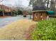 Community entrance with a brick guard house and well-maintained landscaping at 25108 Plantation Dr # 108, Atlanta, GA 30324