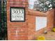 Community entrance with address marker set in brick wall at 