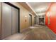 Hallway view with elevators and apartment number, painted in modern neutral colors at 44 Peachtree Ne Pl # 829, Atlanta, GA 30309