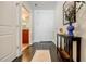 Inviting hallway with hardwood floors, console table, and a glimpse into the bathroom at 44 Peachtree Nw Pl # 829, Atlanta, GA 30309