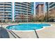 Apartment complex pool with lounge chairs and tall buildings in the background at 44 Peachtree Ne Pl # 829, Atlanta, GA 30309