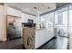 Contemporary kitchen with stainless steel refrigerator and black backsplash, complemented by city views at 44 Peachtree Nw Pl # 829, Atlanta, GA 30309