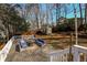 Backyard featuring a spacious wooden deck, outdoor furniture, and a wooden storage shed at 452 Springfield Dr, Woodstock, GA 30188