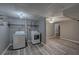 Finished basement featuring laundry area with washer, dryer, tile ceiling and wood-look laminate flooring at 452 Springfield Dr, Woodstock, GA 30188