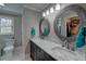 A bathroom with a dual sink vanity with granite countertop and matching framed mirrors at 452 Springfield Dr, Woodstock, GA 30188